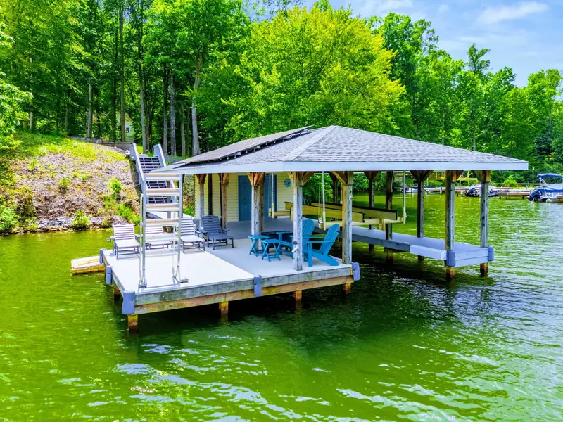 The covered dock pavilion is where the real relaxing happens. Ceiling fan, Adirondack chairs, and nothing but water.