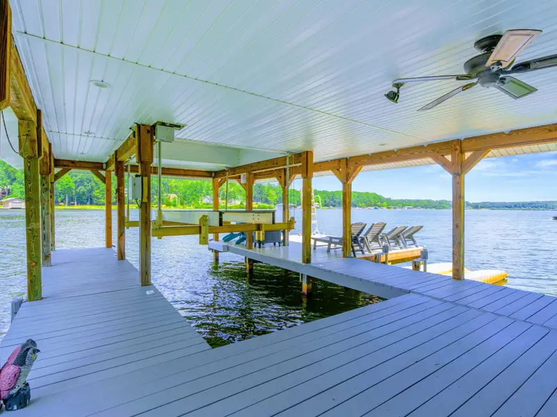 The dock walkway leading out to the covered boat slips and open water.