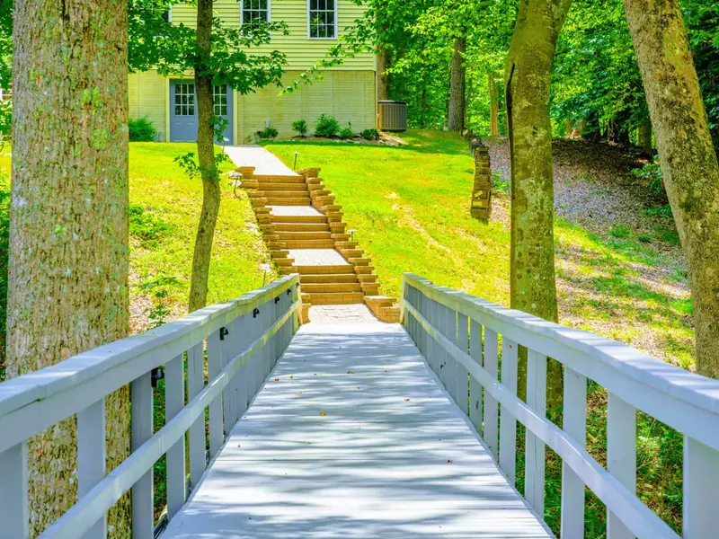 Terraced stone steps connecting the upper yard to the dock. The lake is always just a short walk away.