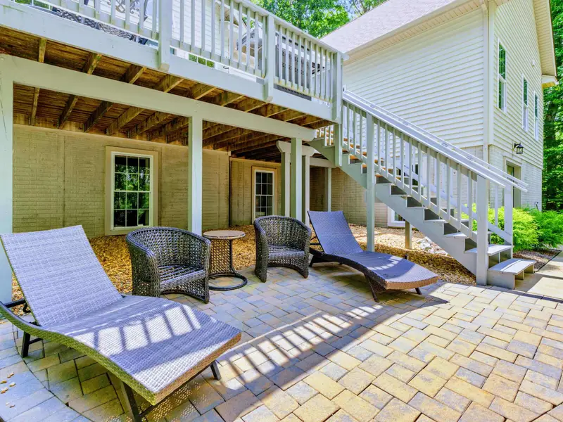 Side deck off the main level with direct access to the yard and grill area.