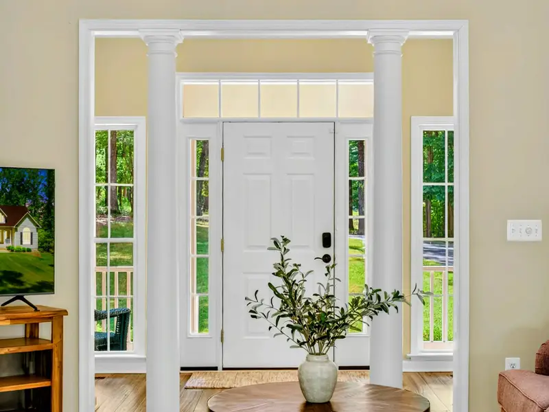 French doors fill the great room with natural light and connect the living space to the deck and lake beyond.
