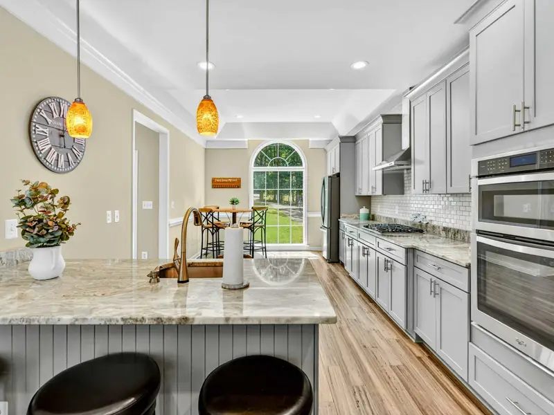 The arched pass-through connects the kitchen to the dining area, keeping the energy and conversation flowing.