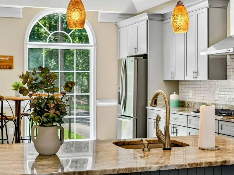 White shaker cabinets, brushed nickel hardware, and modern lighting. Clean, bright, and functional.