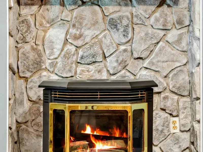 Stone fireplace with a mounted TV above. Movie nights or game days, the lower level has it covered.