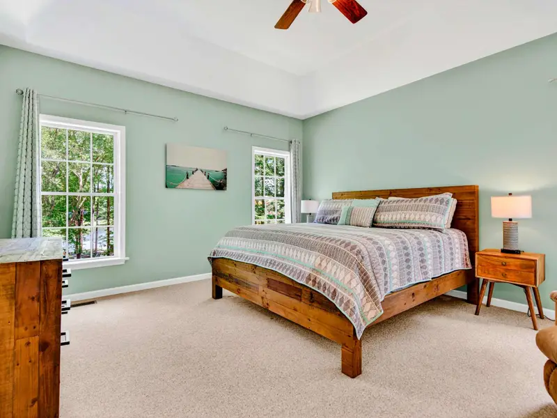 The primary suite: king bed, sage walls, and the kind of quiet that makes you sleep past your alarm.