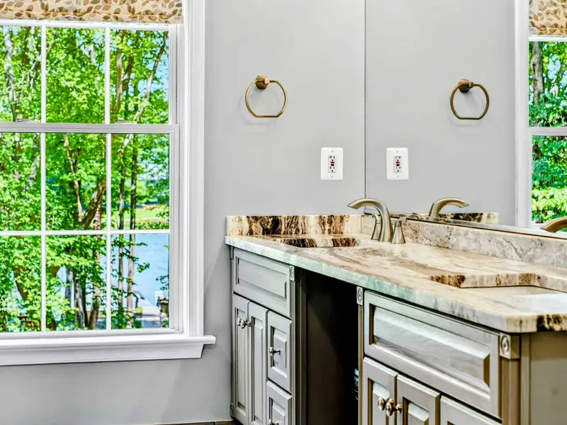 Double vanity with granite countertop. Plenty of space to get ready without waiting in line.