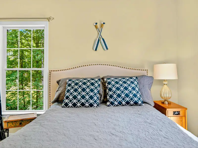 An arched window, decorative oars, and a reading chair. The nautical details are subtle and well done.
