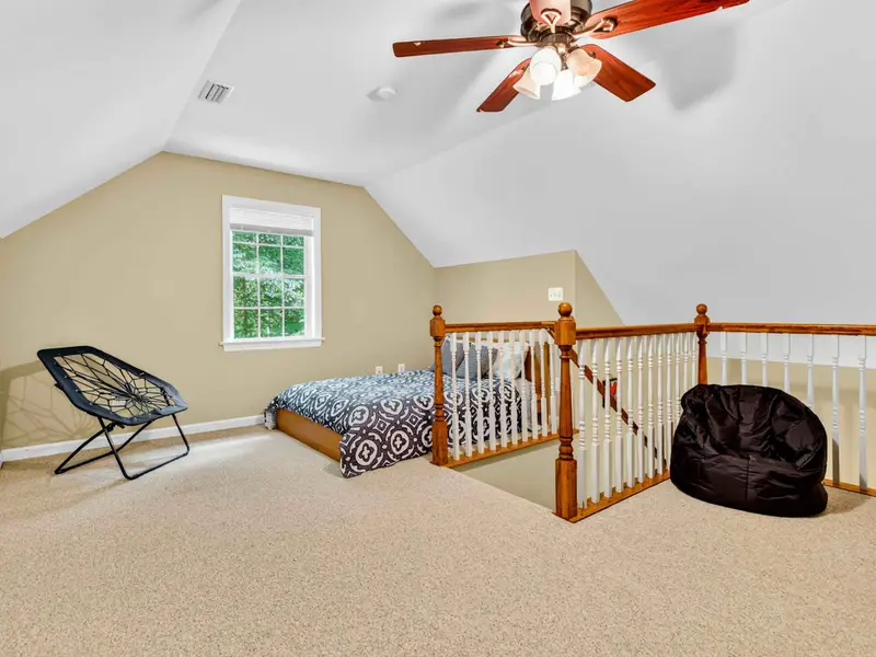 The loft bedroom above the garage: twin bed, bean bags, and open railing with a bird's eye view. Kids love this one.