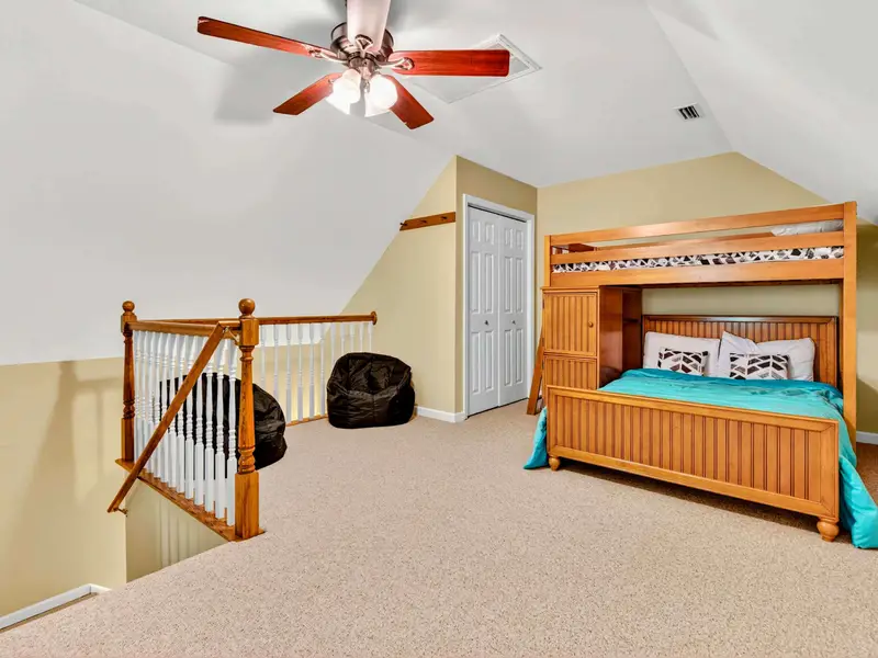 Bunk bed and teal bedding in the loft. A flexible space for kids, teens, or anyone who likes a room with character.