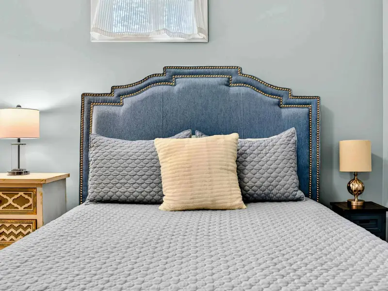 Queen bed with quilted gray bedding. A quiet room that's easy to retreat to after a full day on the lake.