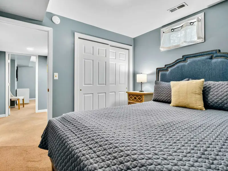 Soft blue walls and recessed lighting. Cozy without feeling small.