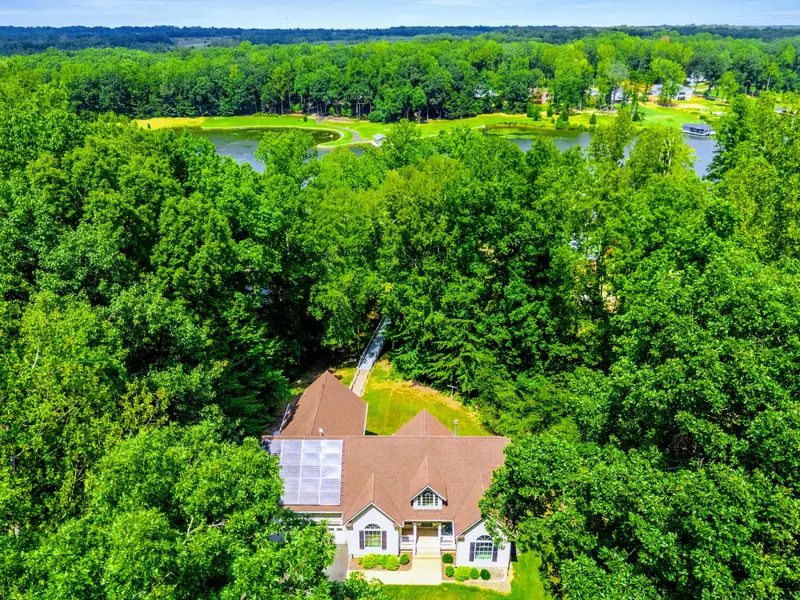 The full property from the air: house, yard, dock, and neighborhood. Lake Anna at your doorstep.
