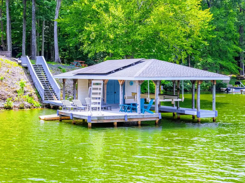 Your morning starts here: coffee in hand, bare feet on the dock, the lake still and golden before the boats come out.