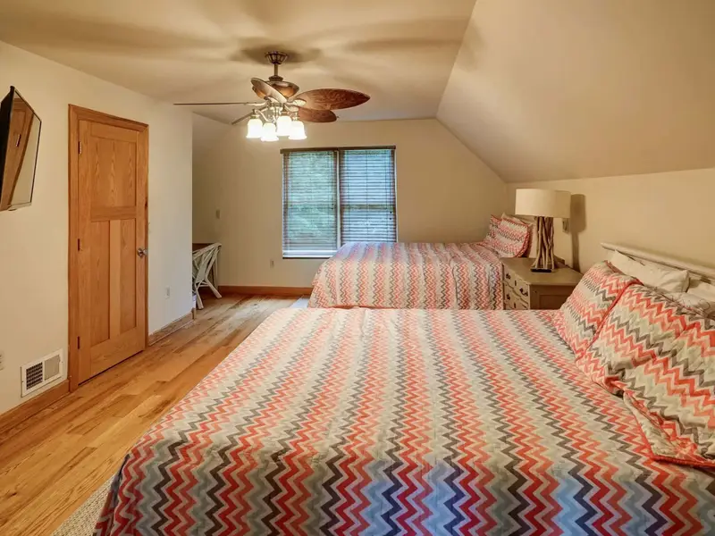 Up in the Treetops - Twin beds tuck perfectly under the sloped A-frame ceiling, with chevron detailing overhead.