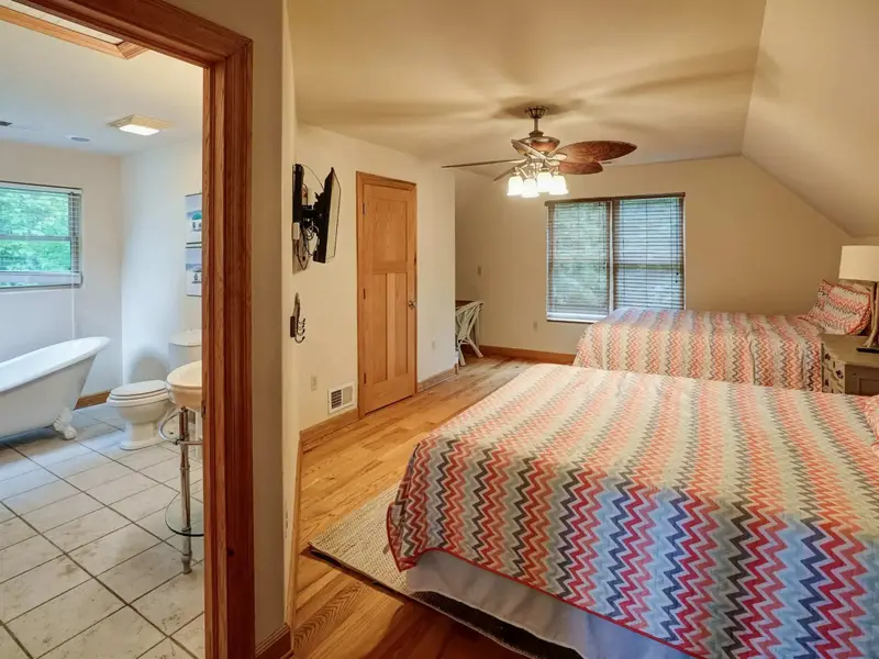 Cozy Under the Eaves - Two beds and a peek at the clawfoot tub beyond make this loft a memorable stay.