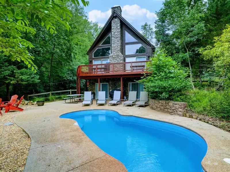 Dive Right In - The private pool is the centerpiece of your lakefront outdoor escape, steps from the water.