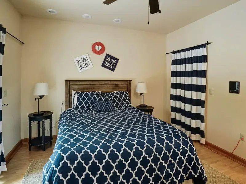 Settle In - Comfortably furnished and thoughtfully designed, the lower-level bedroom is a restful escape for guests.
