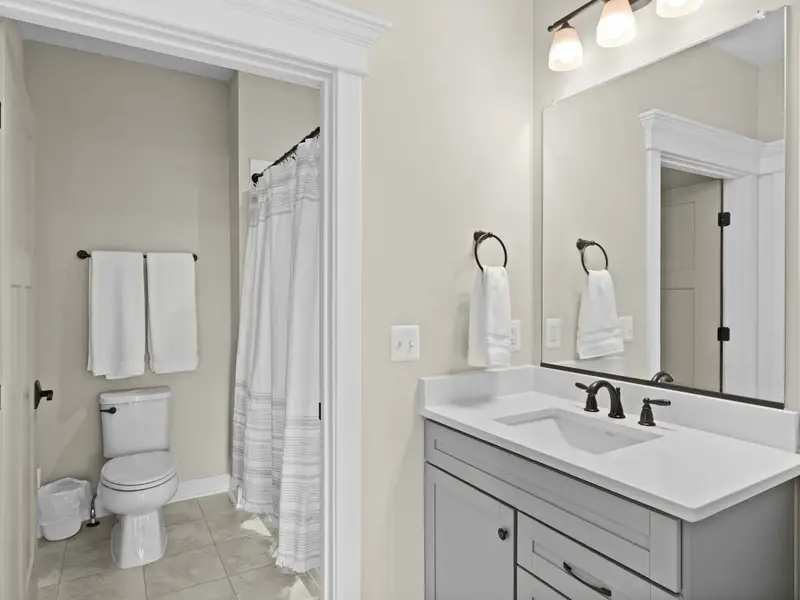 Bathroom - A bright main-floor bathroom with tub-shower combo and vanity, easy access from the main living areas.