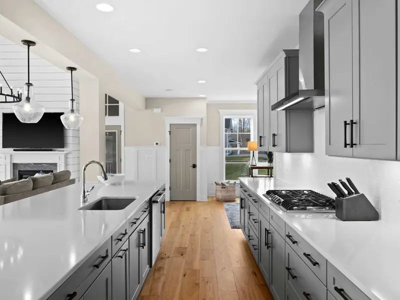 Kitchen - An open kitchen that faces the great room and lake, designed so no one misses the view while dinner comes together.