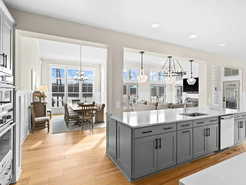 Kitchen - The kitchen island with seating faces the lake side of the home, with the great room fireplace just around the corner.