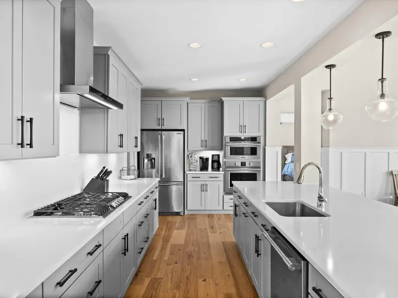 Kitchen - A complete kitchen setup, from the gas range and pot-filler hood to the island sink and dishwasher.