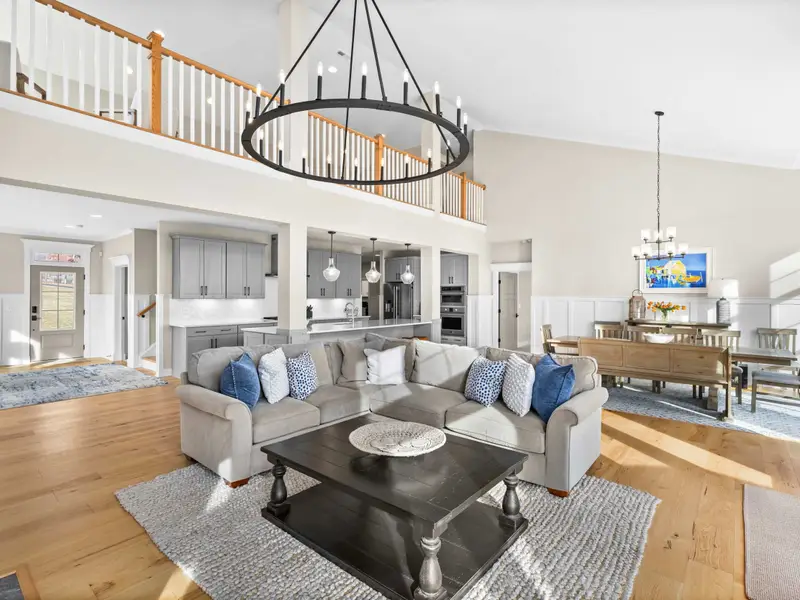 Great Room - From the back corner, the full open plan stretches from the kitchen through the dining area to the lakefront.