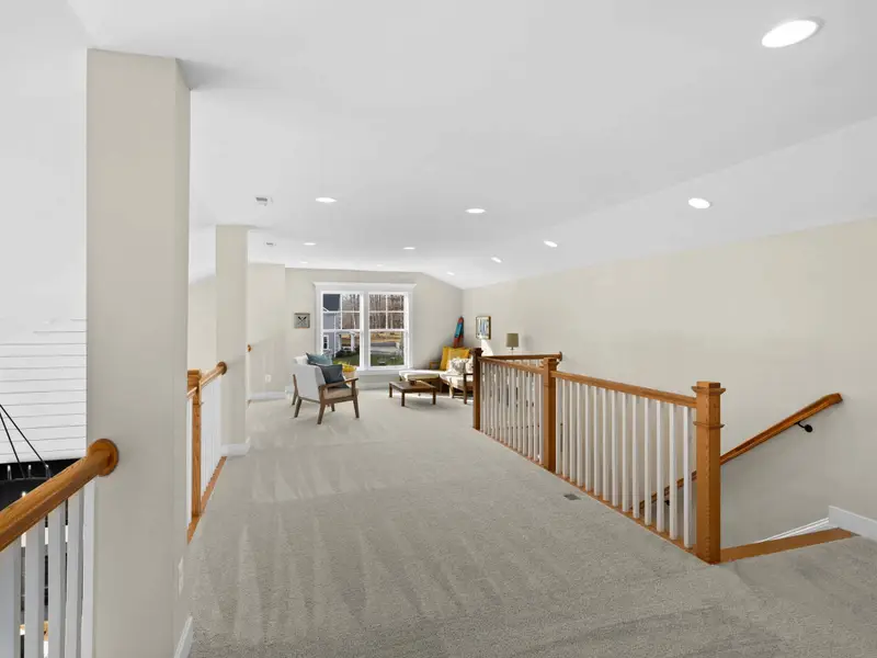 Loft - The open loft hallway with railing overlooking the great room below, connecting the upper bedrooms.
