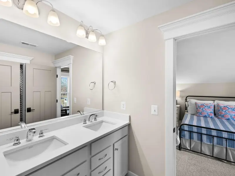 Queen Bedroom - The en-suite bath off the upper queen bedroom, with double vanity and tile detail.