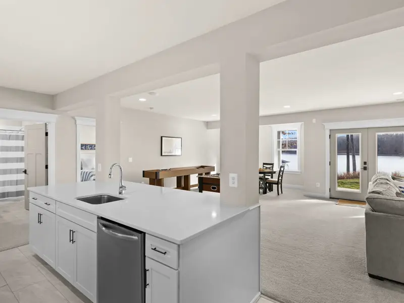 Lower Level Bar - An open kitchenette with island, dishwasher, and direct access to the lower lounge and game room.