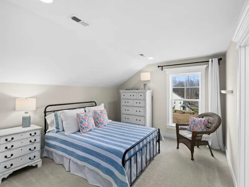 Queen Bedroom - The second upper queen bedroom with blue striped bedding, TV on dresser, and sloped ceiling character.