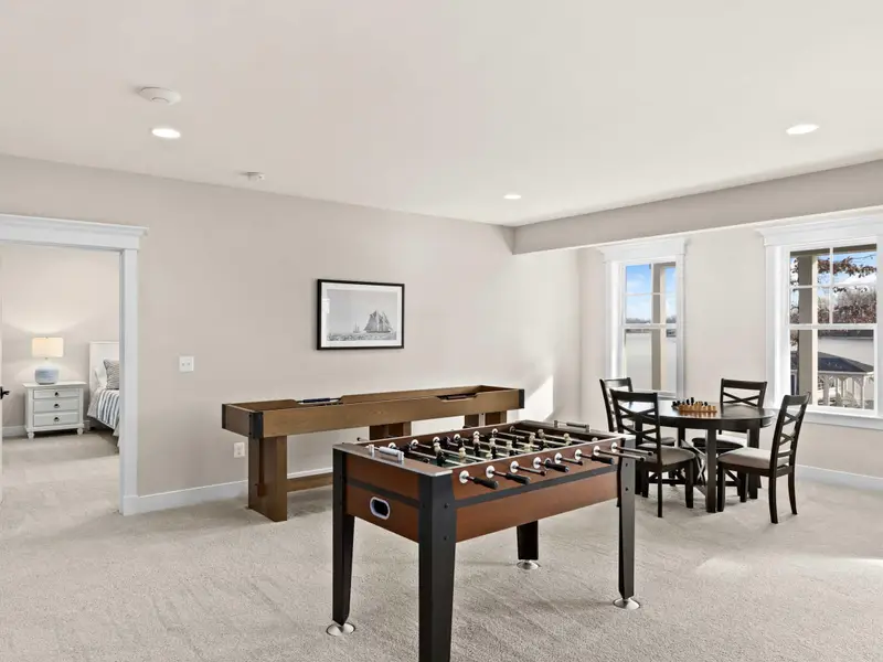 Game Room - Foosball, a card table with chairs, and windows to the lower patio, the room that keeps everyone downstairs after dinner.