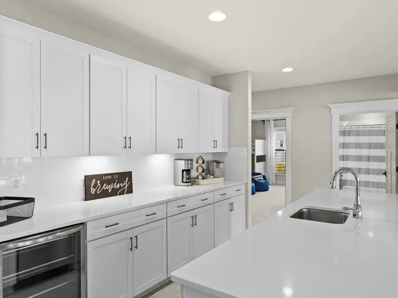 Lower Level Bar - The kitchenette bar from a different angle, with the lower lounge visible beyond.