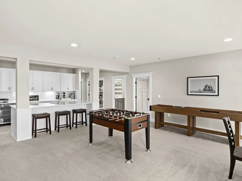 Game Room - Foosball and shuffleboard side by side, with the bar kitchenette just behind and lake views out the windows.