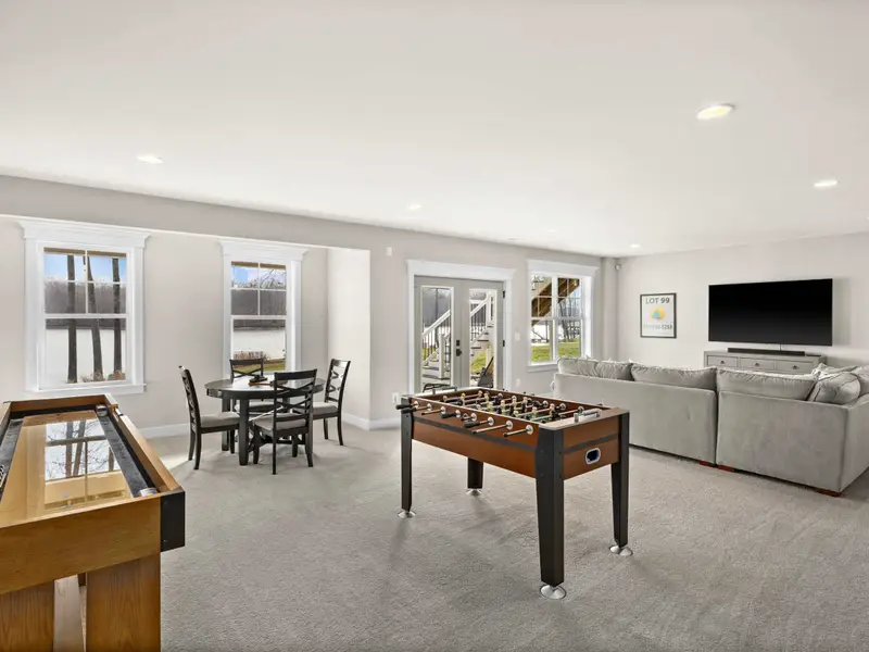 Game Room - The full game room: foosball, shuffleboard, game table, lounge seating, TV, and lake views.