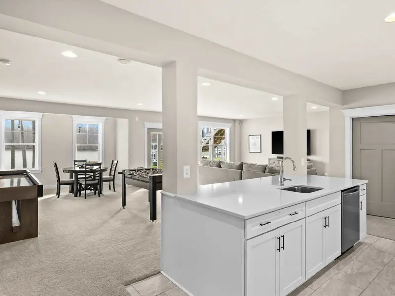 Lower Level Bar - A full kitchenette on the lower level, with island seating, dishwasher, and access to the game room.