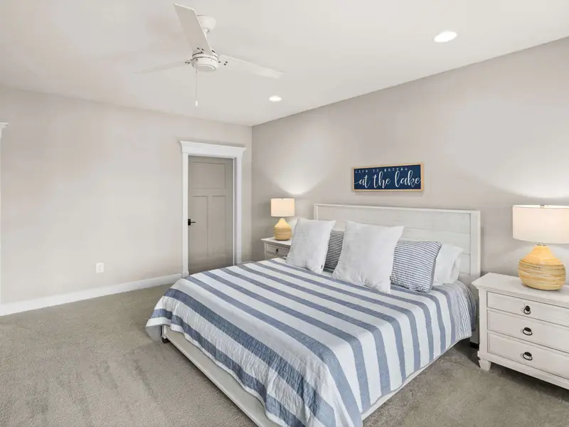 King Suite - Another view of the lower king suite, showing the bed, nightstands, and comfortable room layout.