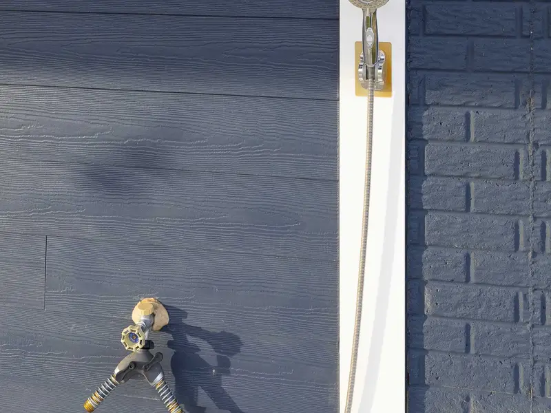 Exterior - An exterior hose bib on the side of the house, convenient for rinsing gear, kayaks, and wet swimwear after a lake day.