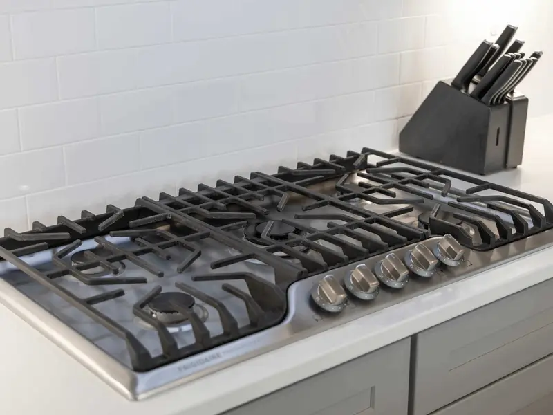 Kitchen - A 5-burner gas cooktop with pot filler and a full knife block, ready for everything from breakfast to a dinner party.