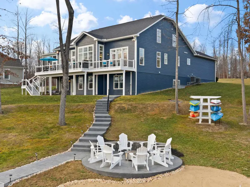 Exterior - From the yard, the fire pit and stepped path to the lake frame the rear of the home perfectly.