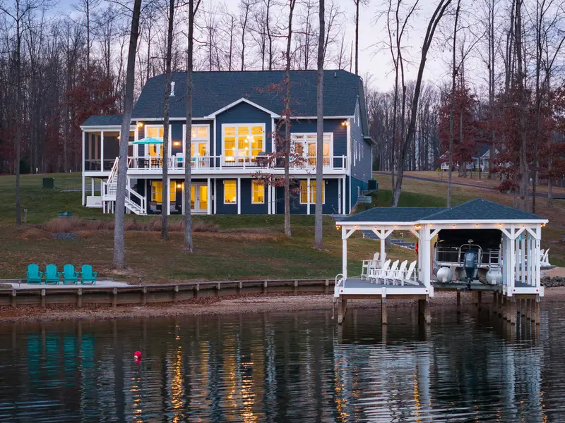 Exterior - Dusk from the lake side showing the house, the boathouse to the right, and the last colors in the sky.