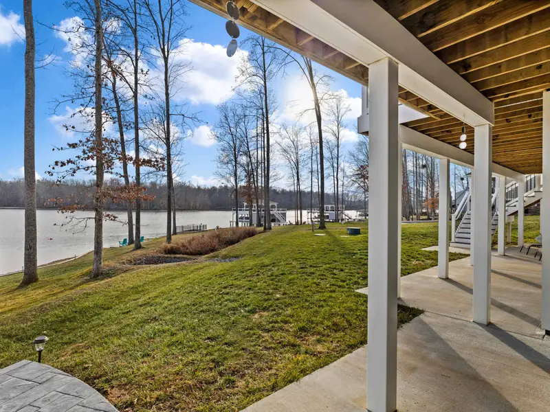 Lower Patio - Column-framed lake views and a concrete floor make the lower patio an easy spot to settle after a swim.