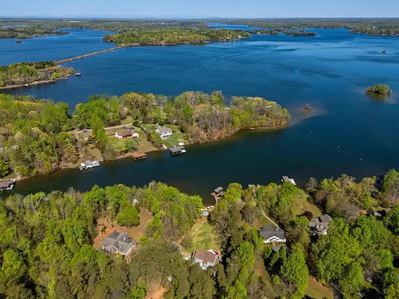 Secluded Bliss: A bird's-eye view of your wooded retreat nestled along a quiet cove.