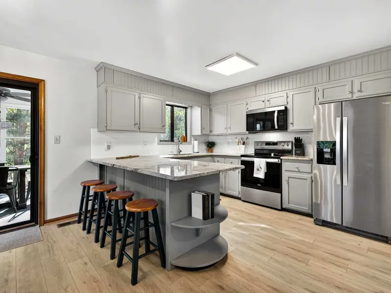 Chef's Kitchen: Sleek gray cabinetry and granite countertops make meal prep a joy.
