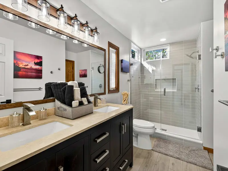 Main Level Spa: A clean, modern full bathroom featuring a double vanity.