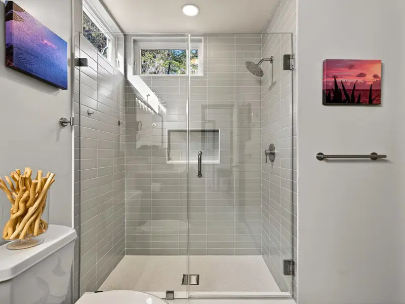 Refresh & Renew: Step into the glass-enclosed shower with custom tile work.