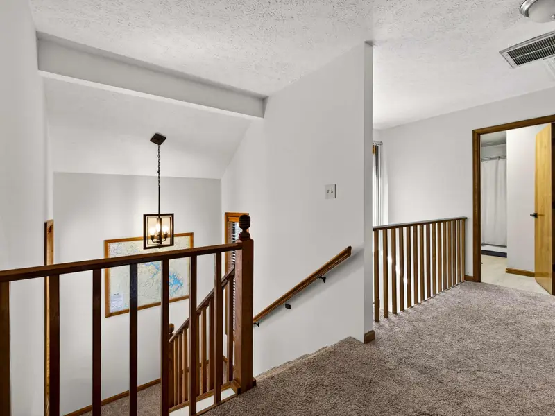 The Loft Gallery: A bright transition space with views overlooking the living room.
