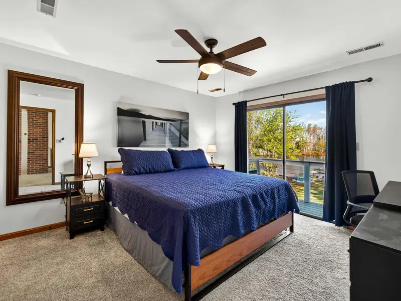 Upper King Suite: Sophisticated navy blue bedding and private balcony access.