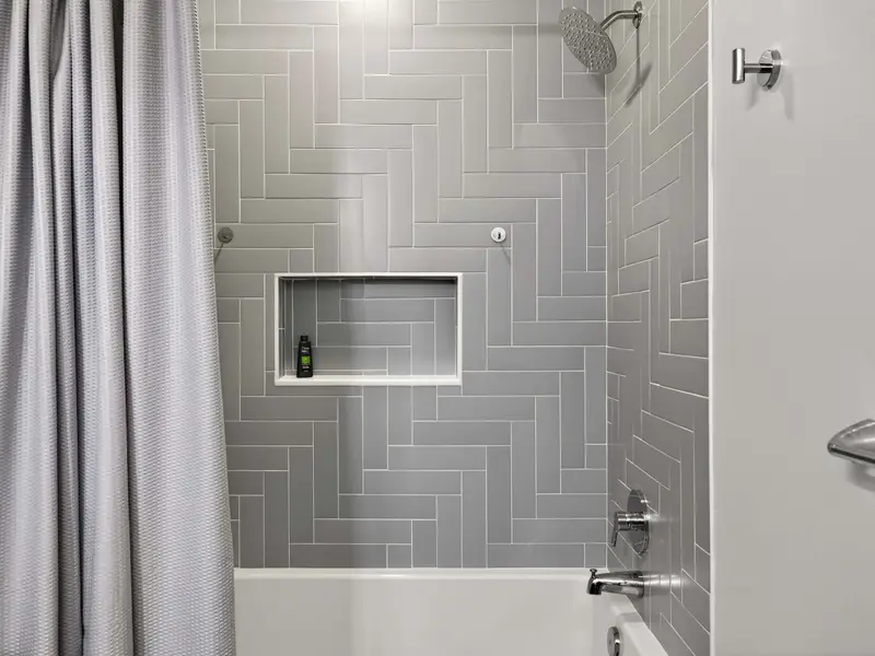 Herringbone Shower: Beautifully tiled tub-and-shower combo for a spa feel.