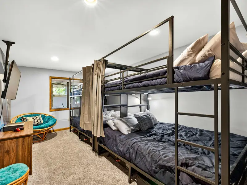Sleepover Central: A bold blue geometric wall adds a fun, modern energy.