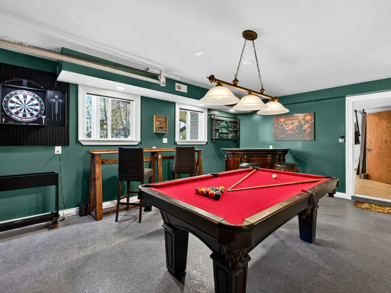 The Billiard Room: Teal walls and red felt create a classic, moody atmosphere.